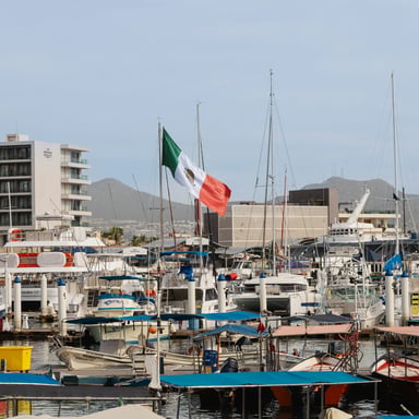 Fishing boats and sailboats at a Mexican marina with the Mexican flag flying