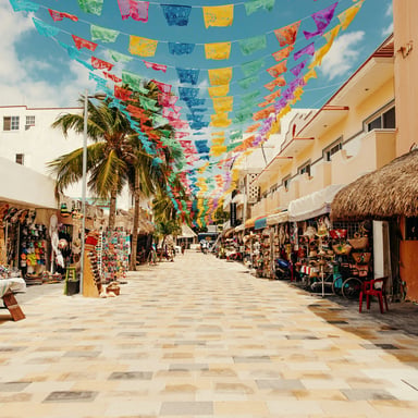 Colorful market street with papel picado flags in a Mexican beach town